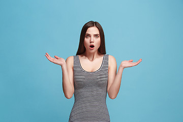 Image showing Beautiful woman looking suprised isolated on blue