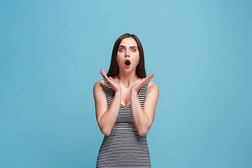 Image showing Beautiful woman looking suprised isolated on blue