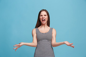 Image showing Portrait of an argue woman looking at camera isolated on a blue background