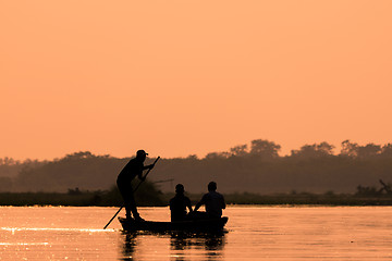 Image showing Men in a boat on a river silhouette