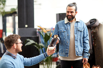 Image showing friends choosing shoes at vintage clothing store