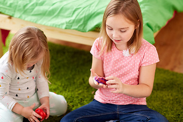 Image showing sisters with modelling clay or slimes at home