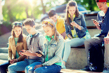 Image showing teenage friends with smartphones outdoors