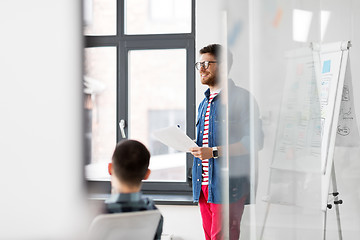 Image showing creative man with papers at office presentation