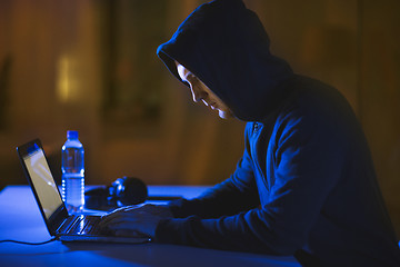 Image showing hacker using laptop computer for cyber attack