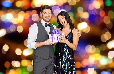 Image showing happy couple with gift box at birthday party