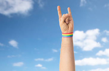 Image showing hand with gay pride rainbow wristband shows rock