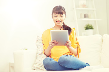 Image showing happy young asian woman with tablet pc at home