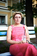 Image showing Adult woman using smartphone on bench