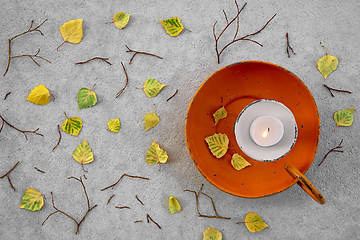 Image showing Autumn leaves and cozy candlelight