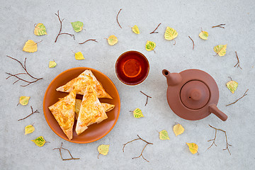 Image showing Tea, pastries and autumn leaves