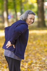 Image showing Senior woman suffering from backache outdoors