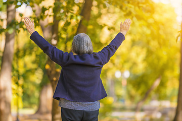 Image showing Happy woman with arms outstretched