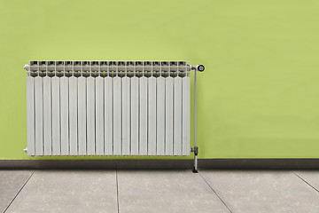 Image showing White radiator in front of the green wall
