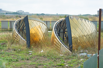 Image showing Parts of the church domes brought for the construction of the church lie on the ground