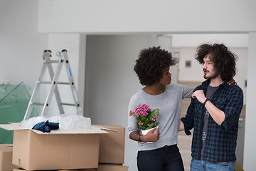 Image showing multiethnic couple moving into a new home