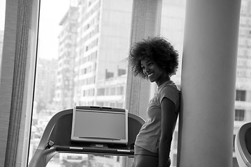 Image showing afro american woman running on a treadmill