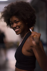 Image showing black woman lifting empty bar