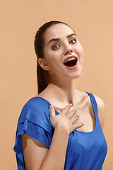 Image showing The happy woman standing and smiling against pastel background.