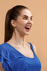 Image showing The happy woman standing and smiling against pastel background.