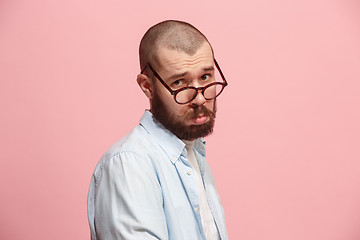 Image showing Beautiful man looking suprised and bewildered isolated on pink