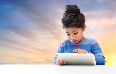 Image showing little girl with tablet pc over evening sky