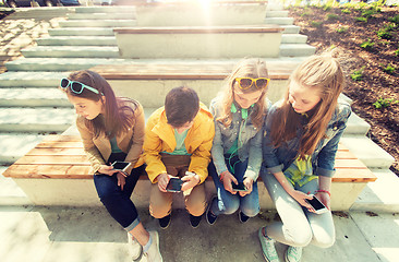 Image showing happy teenage friends with smartphones outdoors