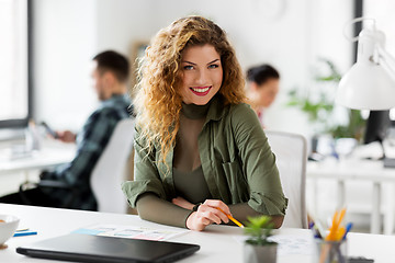 Image showing creative woman working on user interface at office