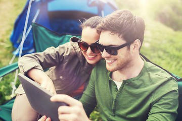Image showing happy couple with tablet pc at camping tent
