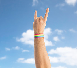 Image showing hand with gay pride rainbow wristband shows rock