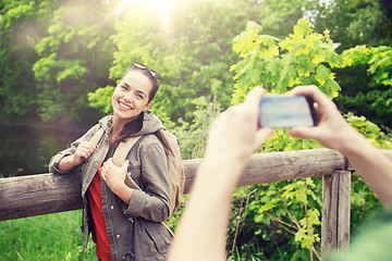 Image showing couple with backpacks taking picture by smartphone