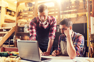 Image showing carpenters with laptop and blueprint at workshop