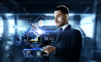 Image showing businessman with transparent tablet and charts