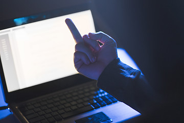 Image showing hacker showing middle finger to laptop