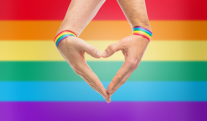 Image showing male hands with gay pride wristbands showing heart