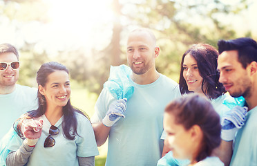 Image showing volunteers with garbage bags walking outdoors