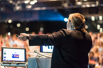 Image showing Female public speaker giving talk at Business Event.