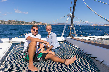 Image showing Romantic couple relaxing on a summer sailin cruise, sitting on a luxury catamaran, sailing in Maddalena Archipelago, Sardinia, Italy.