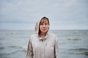 Image showing Smiling young woman standing near sea