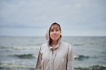 Image showing Smiling young woman standing near sea