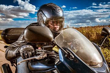 Image showing Biker racing on the road