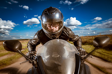 Image showing Biker racing on the road