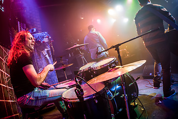 Image showing Drummer playing on drum set on stage.