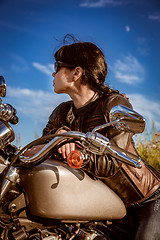 Image showing Biker girl sitting on motorcycle