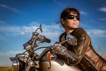 Image showing Biker girl sitting on motorcycle