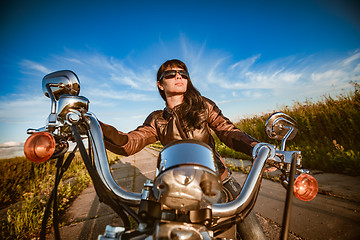 Image showing Biker girl sitting on motorcycle