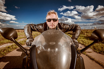 Image showing Biker racing on the road