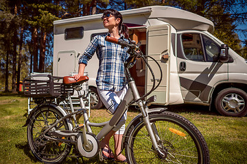 Image showing Woman on electric bike resting at the campsite VR Caravan car Va