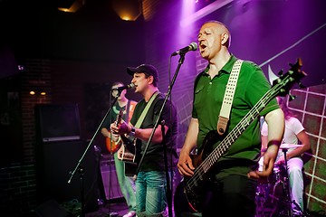 Image showing Band performs on stage in a nightclub
