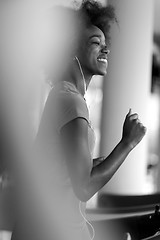 Image showing afro american woman running on a treadmill